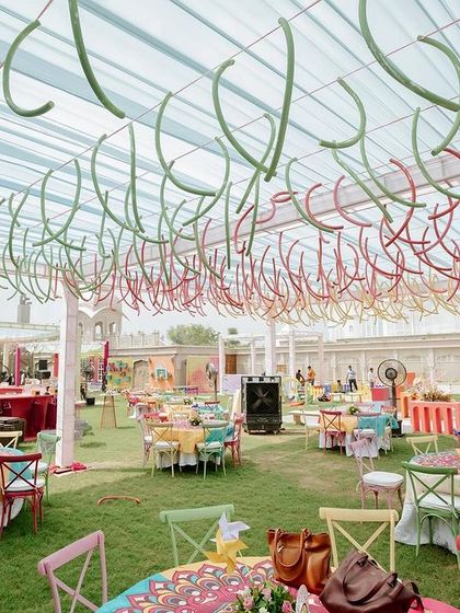 The colorful and dynamic ceiling treatment, using suspended pool noodles in various hues to create a sense of movement and fun.