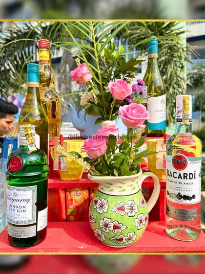 Another example of our minimalist yet elegant bar decor. We use fresh flowers and a curated selection of premium spirits like Bacardi and Tanqueray gin to create a refined look.