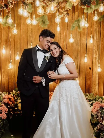 Jennifer and Rydel share a sweet moment under a canopy of warm lights. This portrait is all about creating a cozy, intimate atmosphere that highlights their happiness.