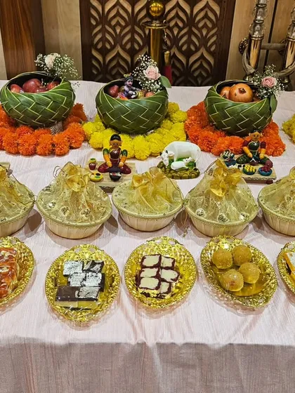 A simple yet elegant food setup for a small function, featuring sweets and fruits in eco-friendly baskets.