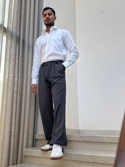 A low-angle shot that gives a sense of power and presence to this classic formal wear look.