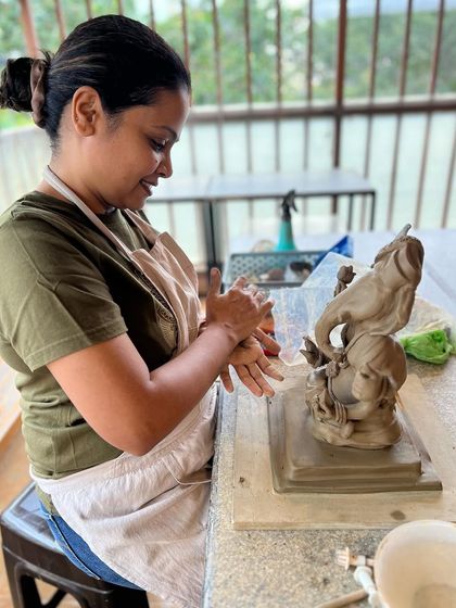 The studio is always full of laughter and creativity during the Ganesha workshops. Here, a student is completely absorbed in her sculpting.