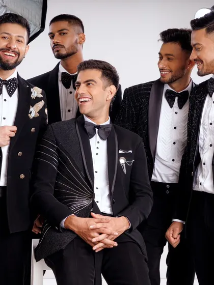 A happy group of models in our bespoke tuxedos. This shot captures the camaraderie and style that our outfits can bring to a groom and his groomsmen.