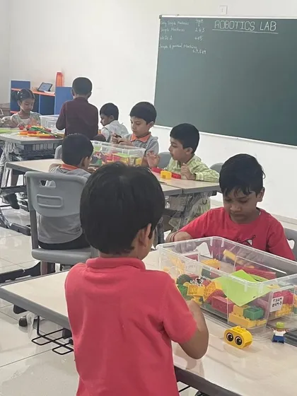 A classroom view of our program at The School for Global Minds, with young children exploring LEGOs at their tables.
