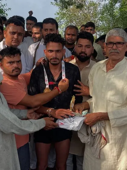 An elder from the village presenting a prize to a winner at the Jaidpura Run. These community events are about more than just running; they are about respect, honor, and local pride.
