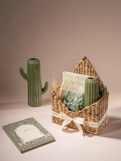 A modern and quirky gift basket from Doro, featuring cactus-shaped vases. The clean, pastel background and minimalist styling give this shot a contemporary and trendy feel.