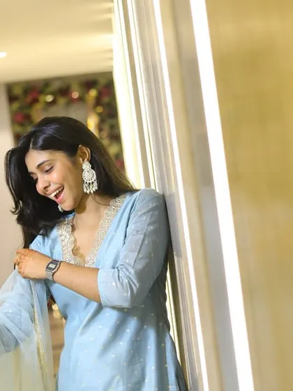 A spontaneous, happy moment captured indoors. We believe the best photos often happen in between the main events, reflecting genuine emotion and personality in a relaxed setting.