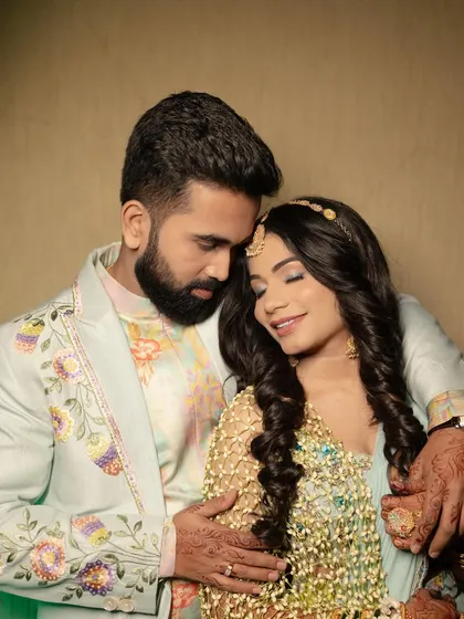 A beautiful, intimate portrait of a couple during their Haldi ceremony, with the bride wearing our signature floral shela.