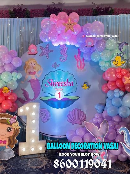 A closer look at our mermaid theme, showing the custom backdrop with an illustrated clamshell and various sea creature cutouts.