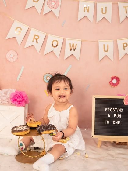 A happy, messy smile that says it all. The aftermath of a successful donut smash is just as cute as the beginning.