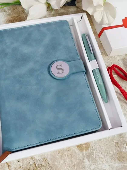 This is my premium diary and pen set in a beautiful Arctic Blue. The faux leather diary features a magnetic lock with a custom initial, and it comes with a matching engraved pen, presented together in an elegant white gift box.