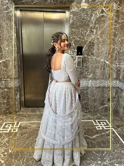 A client looking elegant and poised in a white chikankari lehenga. A timeless and classic look.
