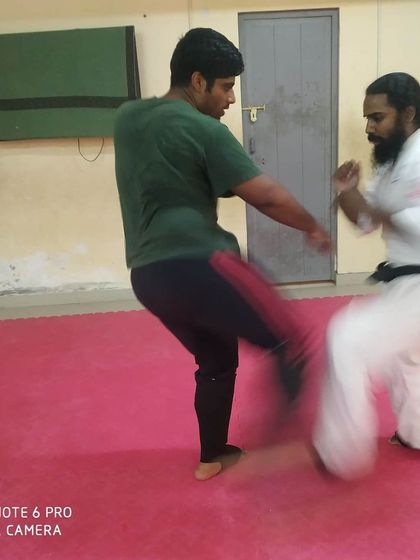 A powerful kick is exchanged during dojo training. This is how we sharpen our tools for competition.