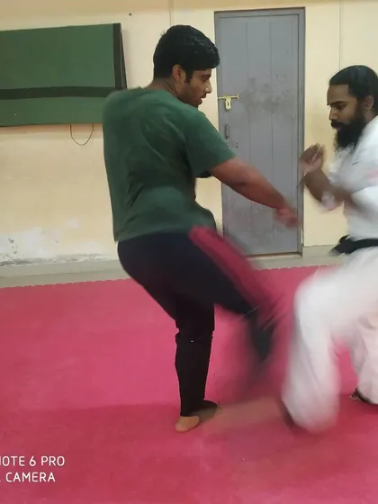 A powerful kick is exchanged during dojo training. This is how we sharpen our tools for competition.