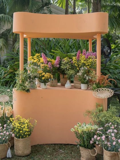 A pastel orange flower cart adds a touch of whimsy and provides a beautiful display for fresh blooms.
