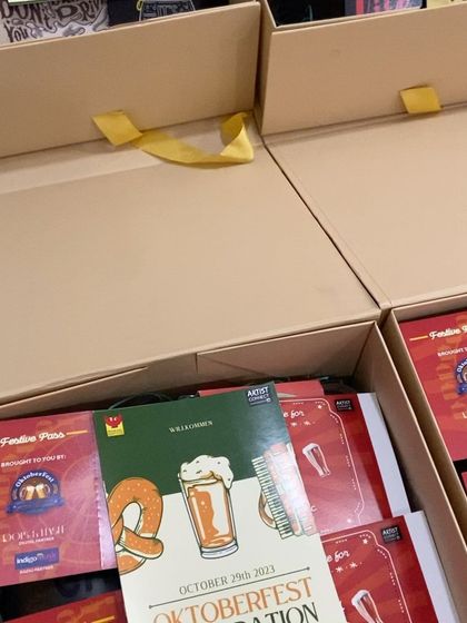 Preparing the Oktoberfest invite hampers for a corporate client, ensuring each box is perfectly assembled.