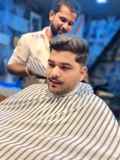 Here I am in action, giving a client a classic scissor-over-comb haircut for a natural and well-groomed finish.