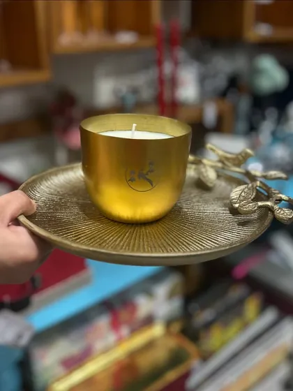 Sharing energy and abundance with pretty gifts for Diwali, like this golden candle on a decorative tray.