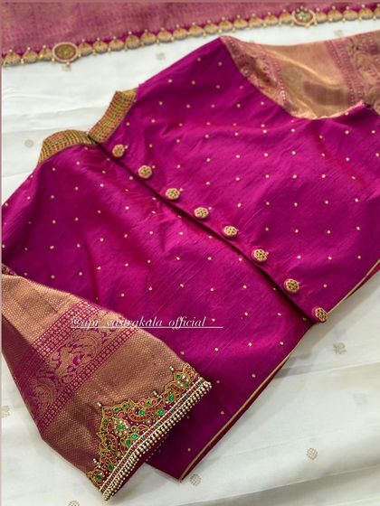 The back of the pink blouse, showing a simple button closure that keeps the focus on the front embroidery.