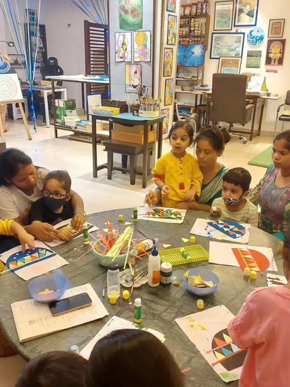 A table of toddlers working on a collage project. Can you guess what they're making? The anticipation is part of the fun!