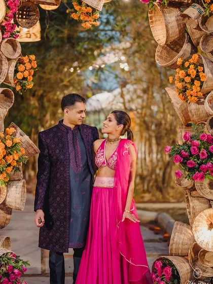 We love crafting unique design elements that reflect our couples' personalities. This stunning Sangeet entrance arch was made from woven baskets and bright florals, creating an unforgettable welcome for guests.