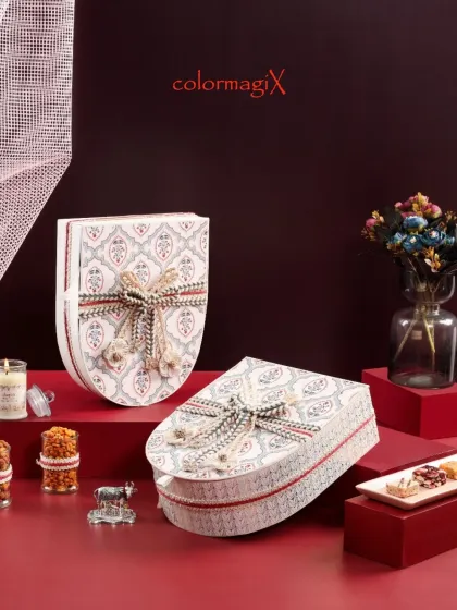 This uniquely shaped shield box features a beautiful traditional print and an intricate woven ribbon. It's a perfect example of our commitment to innovative and elegant design.