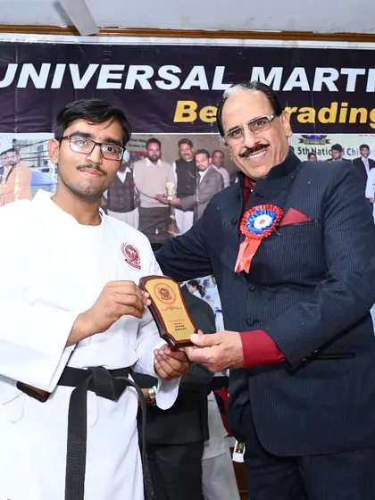Receiving a plaque from the Chief Guest during our belt grading ceremony. It is an honor to have our events recognized by respected community leaders.