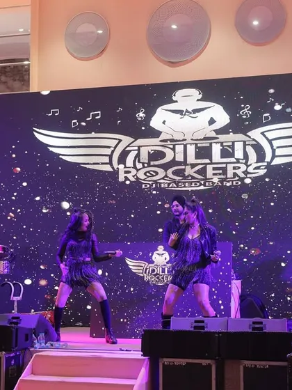 The whole squad, ready to rock. This is our full band lineup on stage, complete with vocalists, percussionists, and our DJ, all set against our signature LED backdrop. We bring a complete, professional entertainment package to your event.