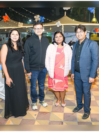 Friends and family gather for a photo at the outdoor section of the party, showing the versatility of the space for both indoor and outdoor celebrations.