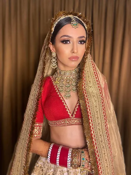 The ultimate Sabyasachi bride. Pawlin's look for her pheras was a sultry smokey eye paired with a classic red lehenga for a truly iconic statement.