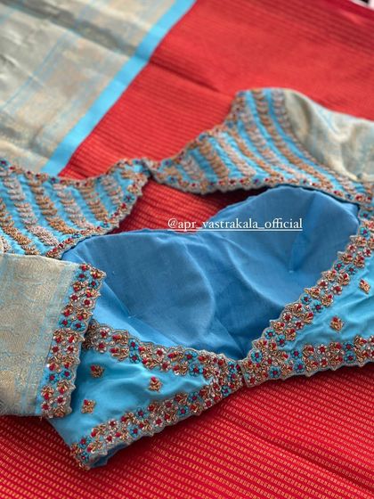 The back of the light blue blouse, with a unique cutout design.