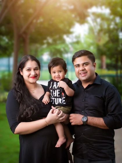 A lovely family portrait taken during an outdoor session. The natural park background provides a relaxed and beautiful setting for capturing your family together.