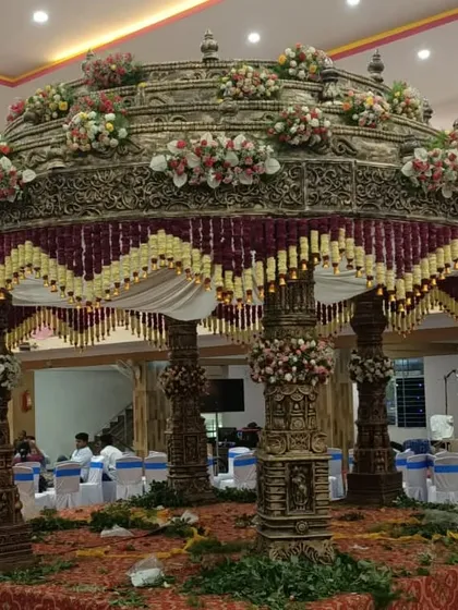 I specialize in creating magnificent, traditional mandaps that become the heart of the wedding ceremony. This is an example of an intricate South Indian mandap, showcasing detailed craftsmanship and floral decoration for a grand celebration.