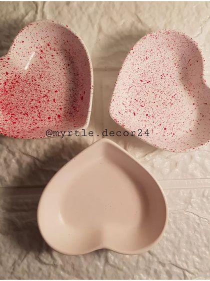 Three of our mini heart dishes, two with a red speckled finish and one in a solid soft pink.