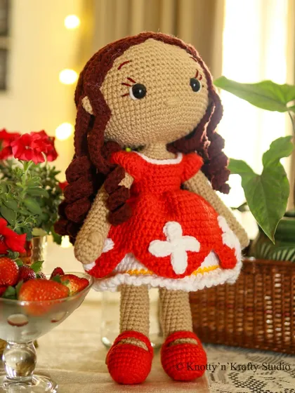 Lily the Doll standing tall, ready for an adventure. At 19 inches, she is the perfect size for a child to hold and carry with them.