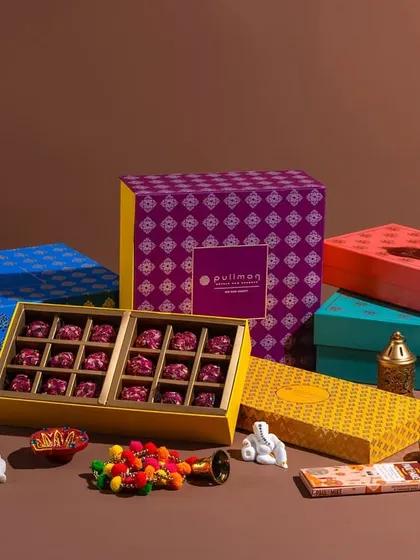 An elaborate collection of festive hampers for Pullman New Delhi Aerocity. This shot displays the full range of their Diwali gifting options, including sweets, cakes, and other gourmet items.