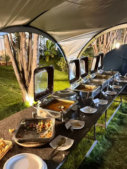 No adventure is complete without great food. We provide a full buffet spread for your team, ensuring everyone is well-fed and energized for the day's activities. This image shows one of our outdoor dinner setups.