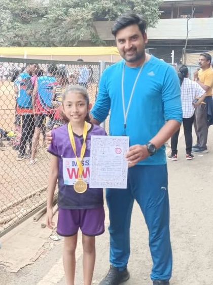 A young athlete proudly showing her gold medal from the MSSA meet.