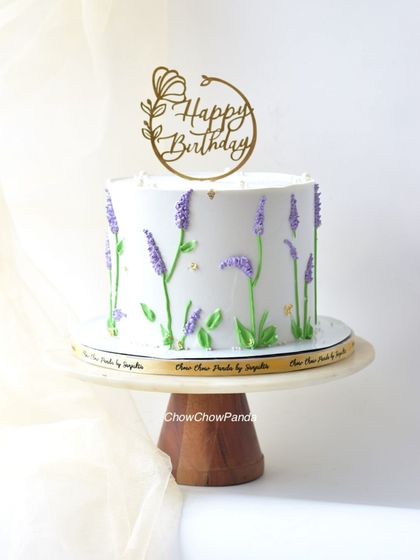A minimalist cake with hand-piped lavender flowers. This simple yet beautiful Choco Vanilla cake is perfect for someone who loves floral designs.