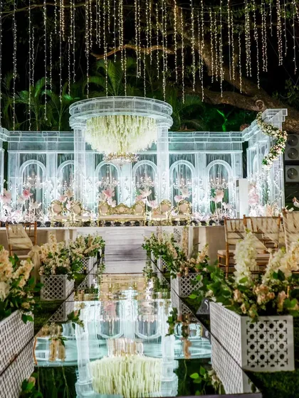 The difference is in the details. This close-up shows the intricate glass-like stage and floral chandelier from one of my premium wedding decor setups, reflecting my commitment to creating a truly breathtaking ambiance.