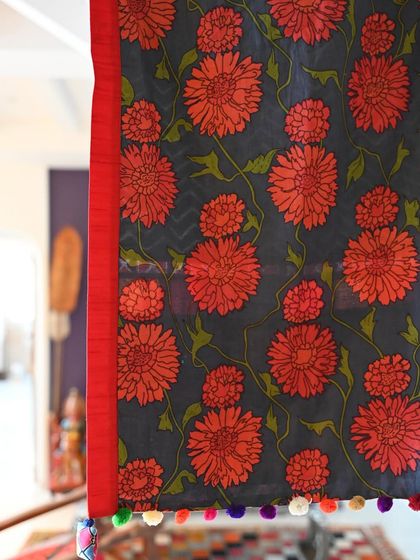 The reverse side of the spring-inspired throw, featuring a bold floral print on a dark background. This reversible feature adds versatility and value to the piece.