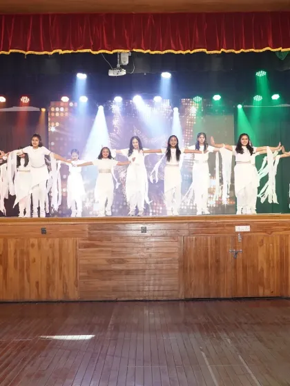 A beautiful, synchronized moment from our junior contemporary performance. The flowing white costumes and dramatic lighting created a stunning visual on stage.