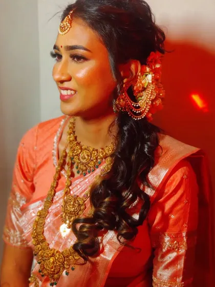 Another shot of Ankita's reception look, highlighting the intricate temple jewellery and the soft curls in her hair.