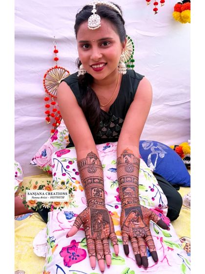 A complete look at the bride's mehndi, featuring portraits and traditional motifs that tell her unique love story.