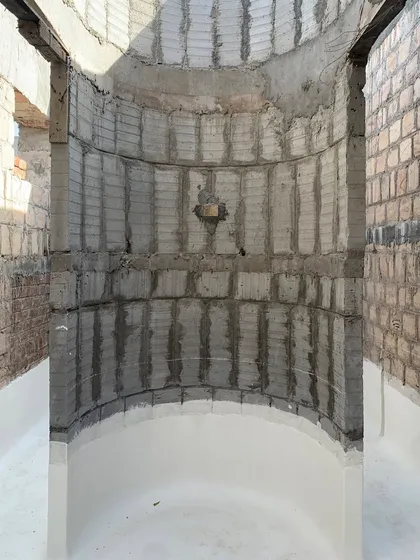 An unfinished, curved space at the House of Galleries. This image captures the raw beauty and potential of the structure during the construction phase.