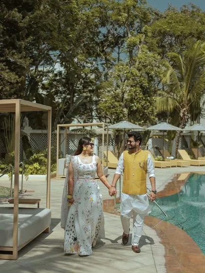 A relaxed walk by the pool. I encourage couples to just be themselves, allowing me to capture candid moments that feel natural and authentic.