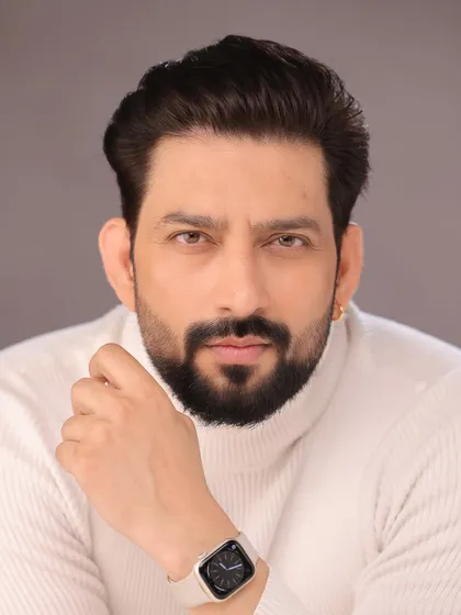 A clean, modern headshot of Aadesh Chaudhary in a turtleneck. This is a great look for a contemporary character portfolio.