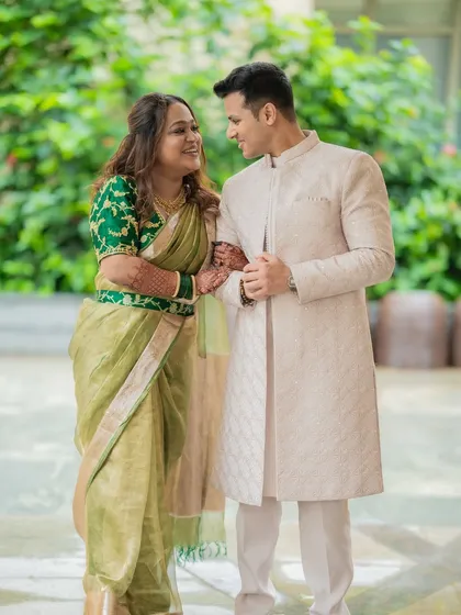 An elegant and classic portrait of Shami and Udit. The pose is traditional and timeless, perfect for a formal announcement.
