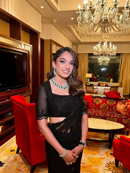The full look, set against a luxurious backdrop. This makeup was designed to be elite, matching the grandeur of the Ambani Sangeet event.