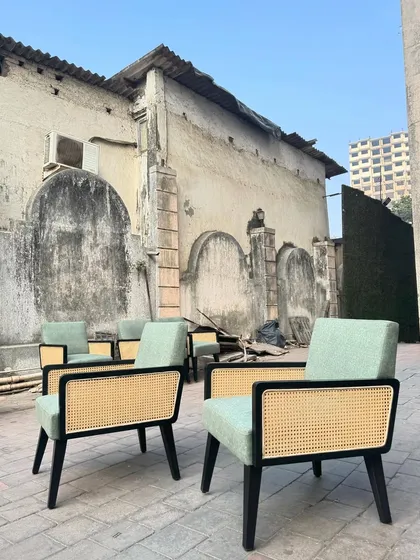 A set of lounge chairs with black frames and sage green upholstery, made for a commercial client.